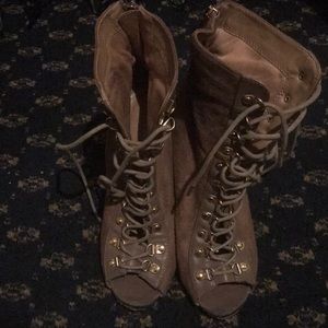 Lace up, peep toe, high heel shoes.